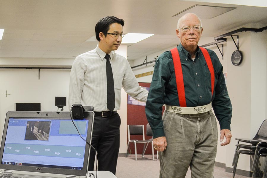 Ka-Chun Siu, PhD, with a study participant working on a walking test.
